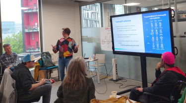 Accessibility collega Severine presenteert op de Hogeschool Utrecht voor een klas vol luisteraars